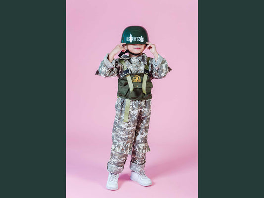 Boy in Navy Seals uniform smiling